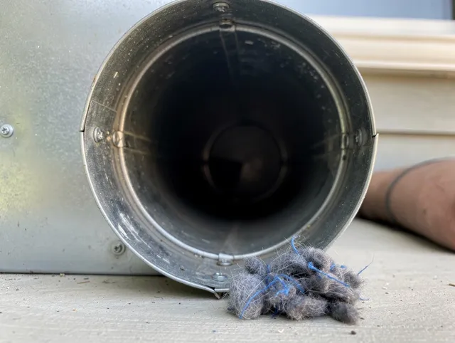 West Carson Dryer Vent Cleaning technician using specialized equipment to clear severe dryer vent blockage in West Carson